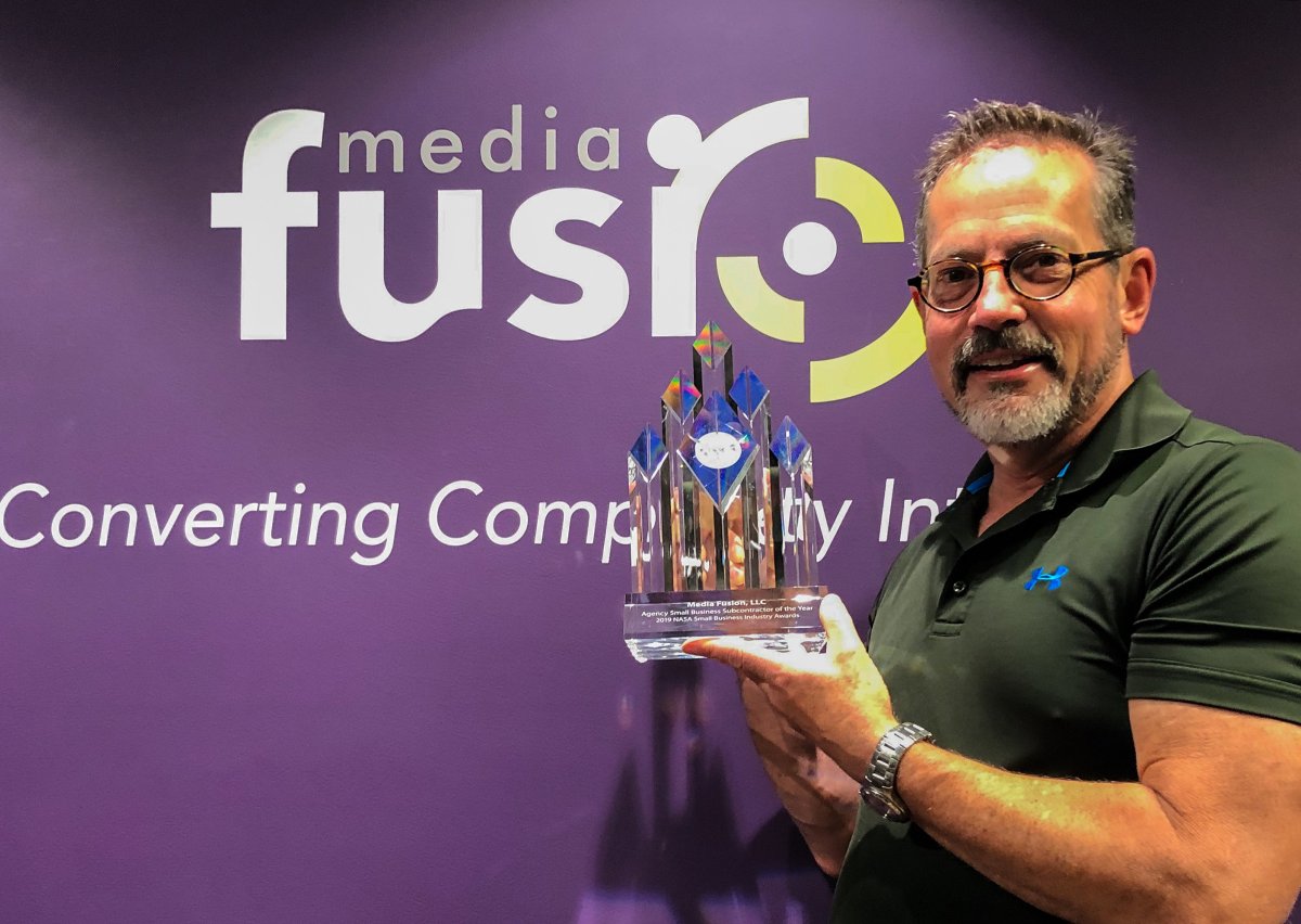 Media Fusion founder Tim McElyea holding a NASA Agency Small Business Subcontractor of the Year award