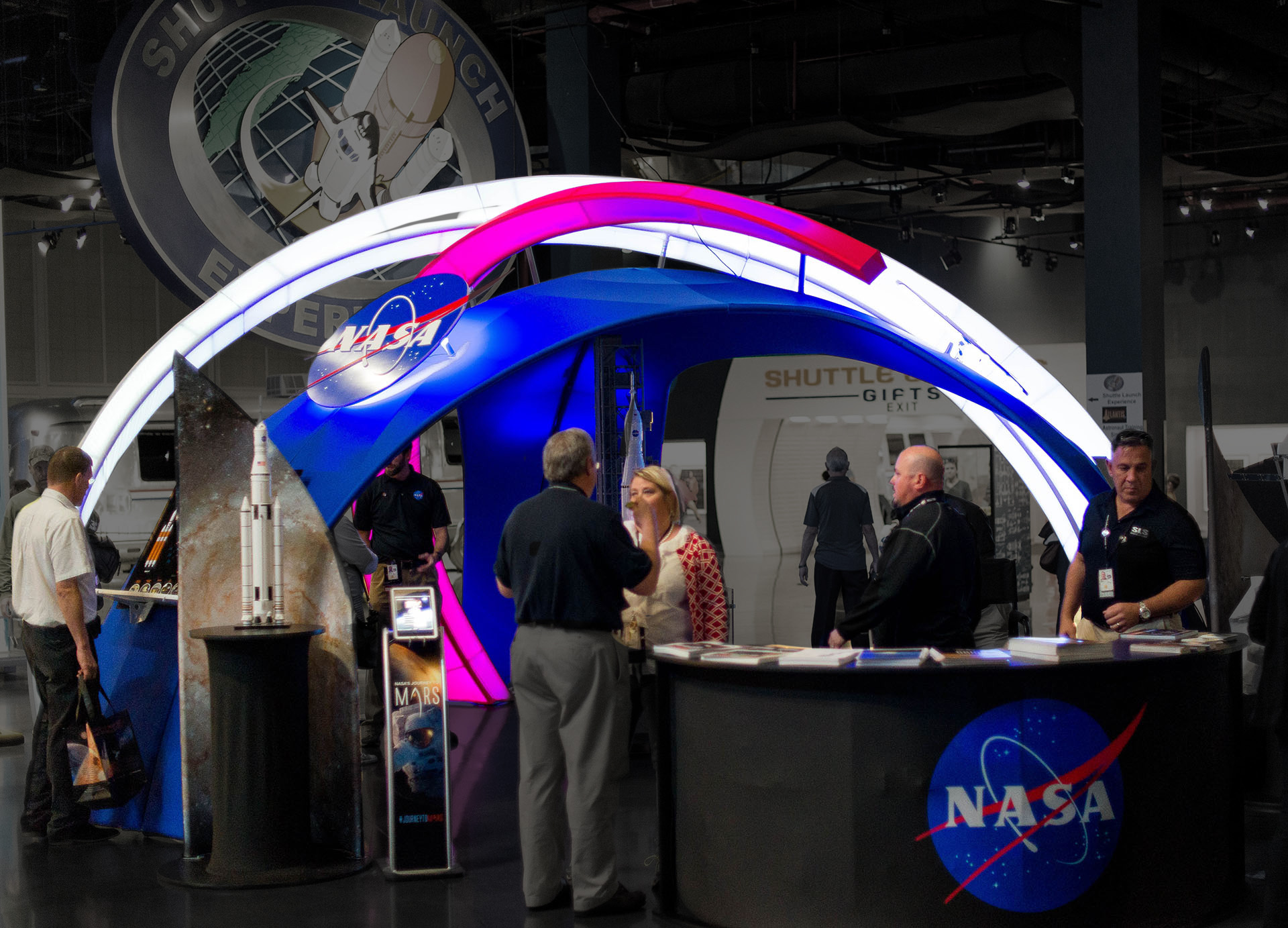 A NASA exhibit created by Media Fusion, featuring scale models, illuminated structures, and interactive kiosks